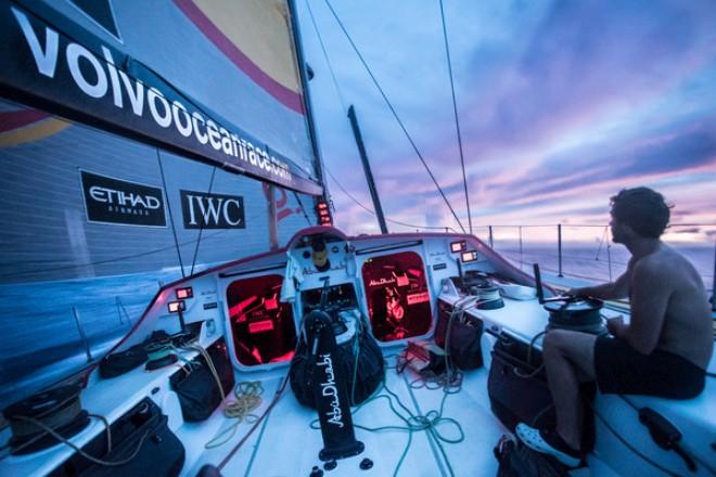 Abu Dhabi Ocean Racing - Roberto Bermudez 'Chuny' sits along on his watch as the fires in the sky kick into gear as the team heads for hopefully the last of the rain squalls at dusk in the Doldrums - Volvo Ocean Race 2014-15 © Matt Knighton/Abu Dhabi Ocean Racing